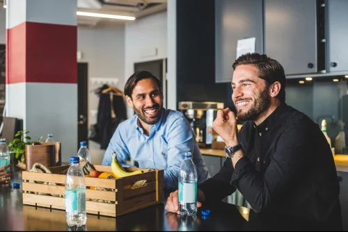 Business meeting in office with people discussing charts on screen